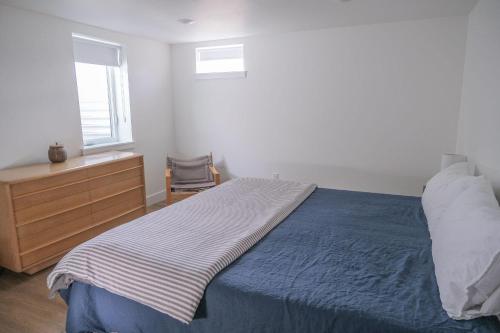 a bedroom with a bed and a dresser and a window at The Holiday Rambler in Livingston