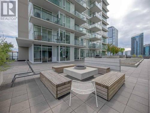 a patio with benches and a table and a building at Modern Suite Calgary Downtown 5 min walk Stampede in Calgary