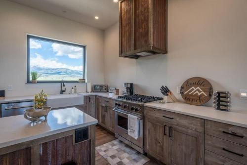 a large kitchen with wooden cabinets and a window at Double MM Ranch in Emigrant