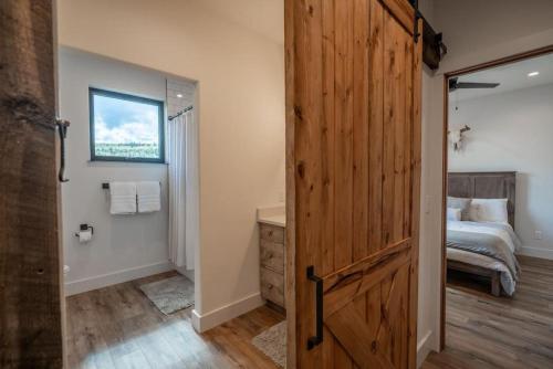a bathroom with a wooden door leading to a bedroom at Double MM Ranch in Emigrant