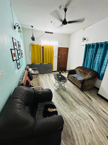 a living room with a couch and a table at BACADI INN Tourist home in Ernakulam