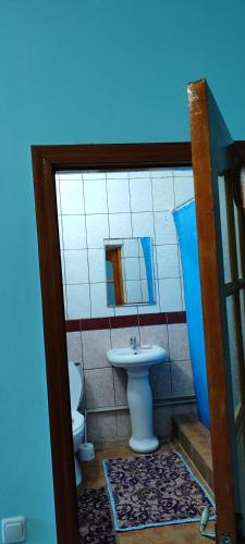 a bathroom with a sink and a toilet at Азия Hotel in Taraz