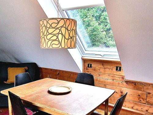a dining room with a table and chairs and a window at Amunds Apartment in Bergen