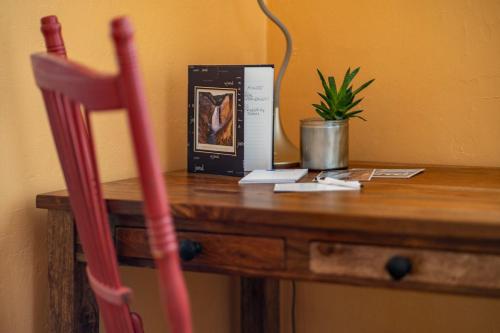 a wooden table with a chair and a book on it at The Downtown Lovely in Livingston