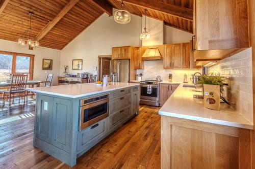 a large kitchen with a blue island in the middle at Osprey Acres in Emigrant