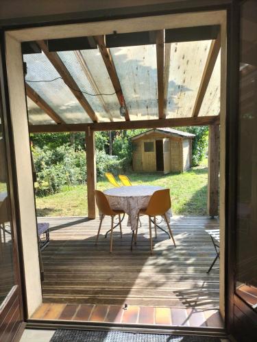 un patio avec une table et des chaises sur une terrasse dans l'établissement Studio équipé terrasse et jardin, à Vielle-Saint-Girons