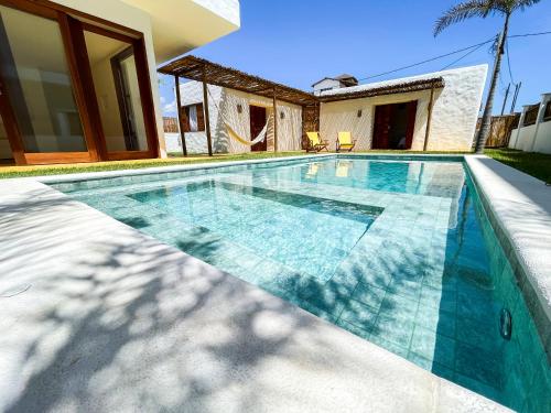 a swimming pool in the backyard of a house at Casamaré Guajiru in Trairi