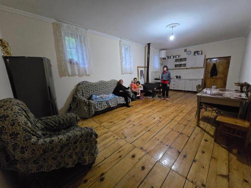 a group of people in a living room at Sarag Mountain & Family Guesthouse Svaneti in Mestia