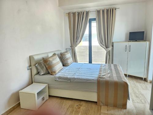 En eller flere senge i et værelse på Luxury Mamaia Nord