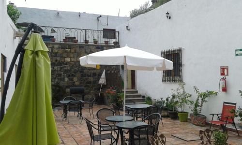 a patio with tables and chairs and an umbrella at MVO parras in Parras de la Fuente