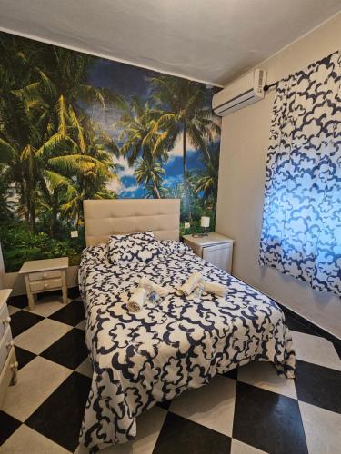 a bedroom with a bed and a palm tree mural at Hostal Sevillana Costa in Chipiona
