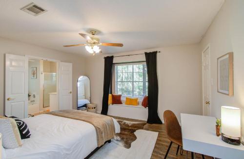 a bedroom with a bed and a ceiling fan at 4BD - Pool & Movie Theater - Lake Conroe Nearby in Conroe
