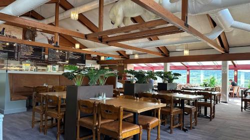 a dining room with wooden tables and chairs at Kroderen Kro & motel AS in Hamremoen