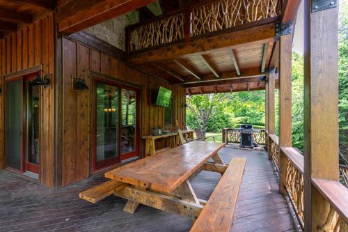 a wooden table on the porch of a cabin at Rivers Edge at Eagles Nest in Banner Elk
