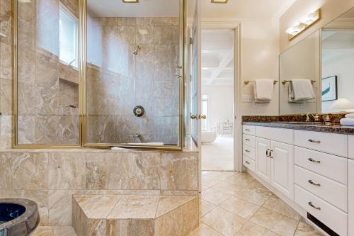 a bathroom with a shower and a sink at Breakers Way Dream in Carpinteria