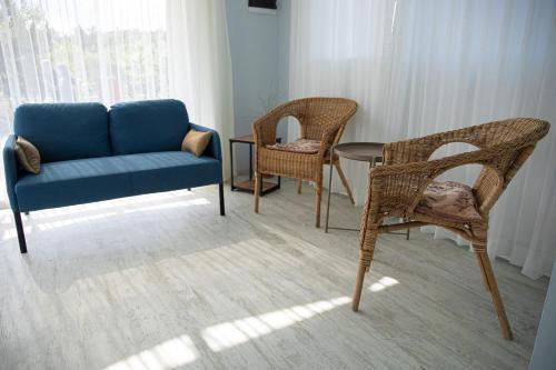 a living room with a couch and chairs and a table at Gadura Kır Evleri Urla in Urla