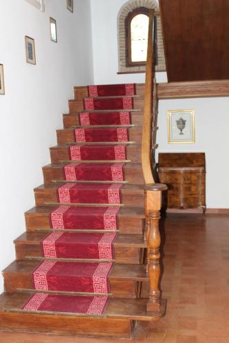 a staircase in a house with a red carpet at Villa Orio Lake Piediluco in Piediluco