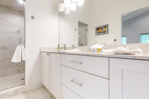 a white bathroom with a sink and a mirror at Sunlight cottage in Steamboat Springs