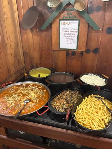 a group of trays of food on a table at Hotel Fazenda São Moritz in Teresópolis