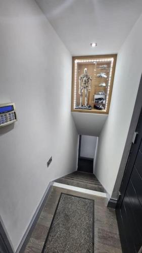 a stairway with a picture of a man on the wall at Luxury 1 Bed Coach House in Huddersfield