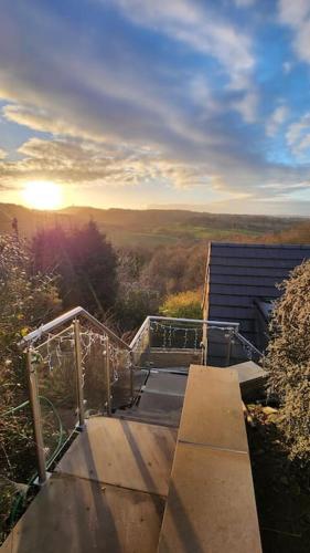 a view of a wooden ramp with the sun in the background at Luxury 1 Bed Coach House in Huddersfield
