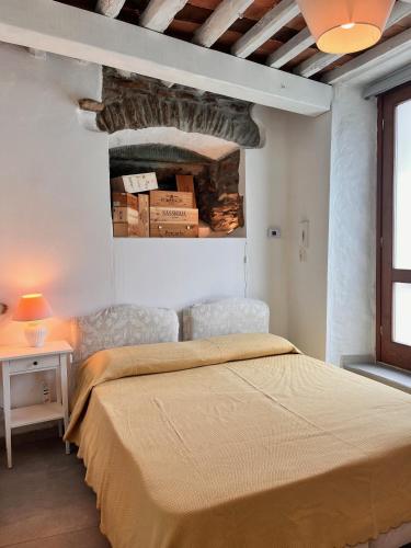 a bedroom with a bed and a table and a window at Appartamento BIANCA in Montignoso