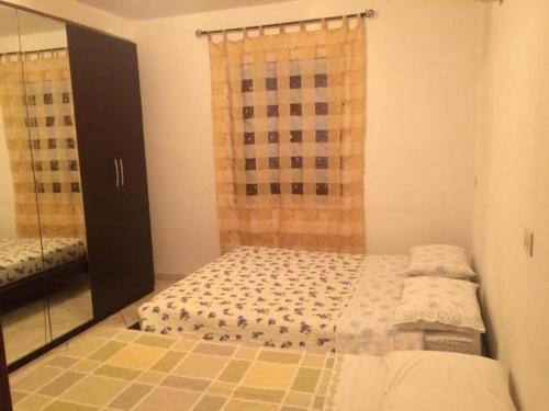 a small bedroom with a bed and a mirror at CasaGiarelli in Monti di Licciana Nardi