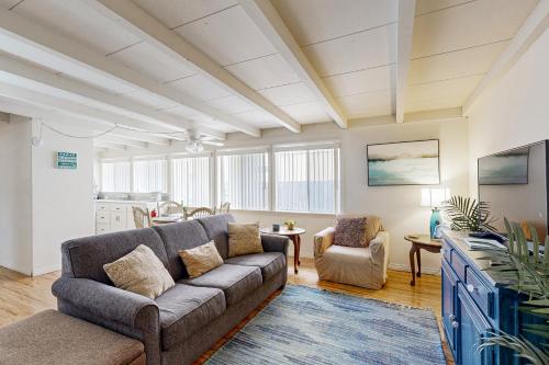 a living room with a couch and a table at Sailaway Cabin A in Ventura