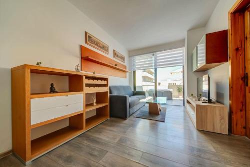 a living room with a couch and a tv in it at Modern Penthouse Near Gzira Seafront in Il-Gżira