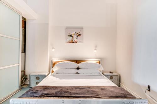 a bedroom with a bed with a cow picture on the wall at Downtown Los Angeles Condo with Rooftop Pool Access in Los Angeles