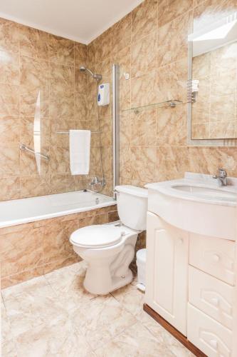 a bathroom with a toilet and a sink and a shower at Hotel Serena Suite in La Serena