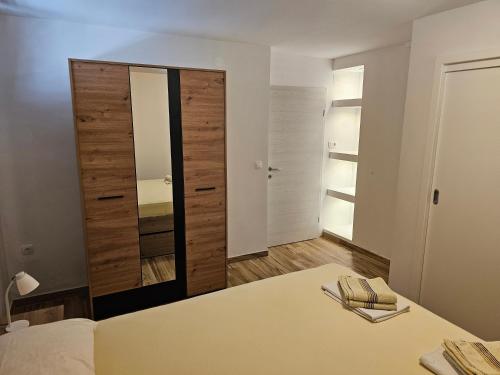 a bedroom with a mirror and a bed in a room at Villa Kučan in Porat