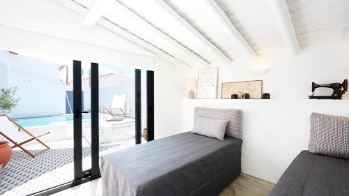a bedroom with a bed and a pool at Casas da Amieira - Casa Terracota in Amieira
