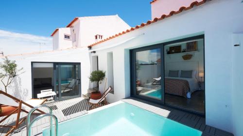 a villa with a swimming pool and a balcony at Casas da Amieira - Casa Terracota in Amieira