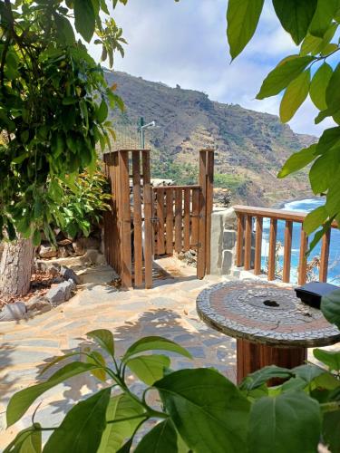 a wooden deck with a table and a view of a mountain at La Era de Catuja in Los Realejos
