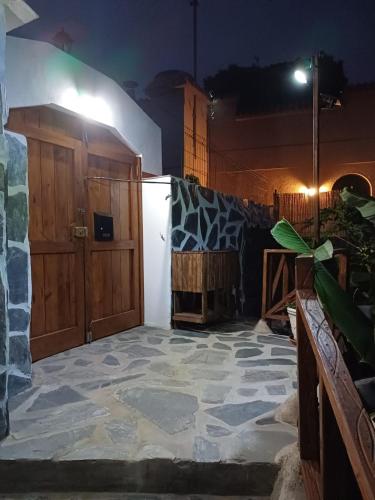 a patio with a stone floor and wooden doors at La Era de Catuja in Los Realejos