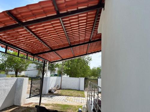 awning over a patio of a house at Emerald Village in Kālapettai