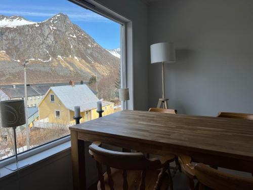 a dining room table with a view of a mountain at FeelSenja Gryllefjord Holiday House in Gryllefjord