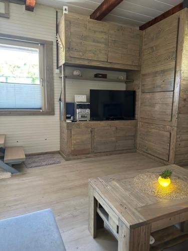 a living room with a table and a tv at Močvirski Tulipan in Ljubljana