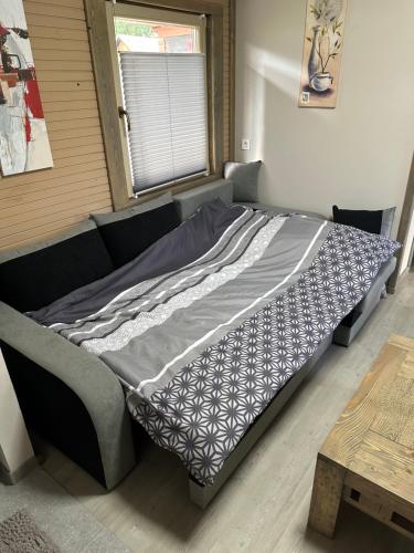 a large bed in a room with a table at Močvirski Tulipan in Ljubljana