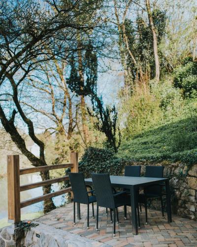 a table and chairs sitting next to a fence at Riverside House Krka in Zagradec
