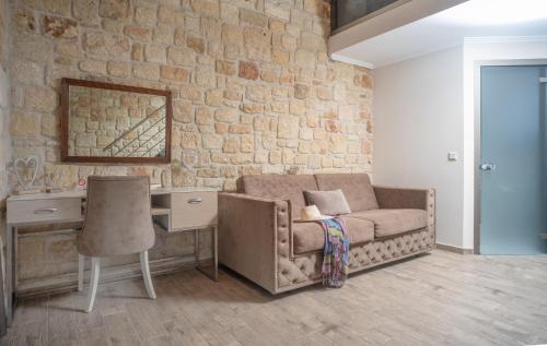 a living room with a couch and a desk at Villa Palma in Kallithea Halkidikis