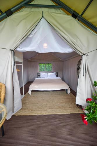 a bedroom in a tent with a bed in it at KempingZator Glamping in Zator