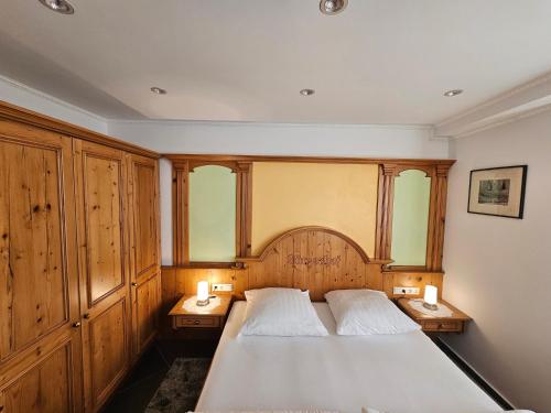 a bedroom with a large bed with two night stands at Ferienhaus Harmonie Kulmbach Zentrum in Kulmbach