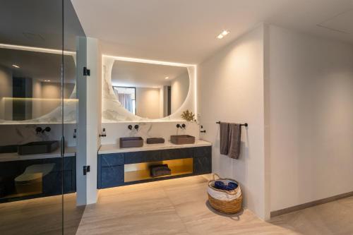 a bathroom with a sink and a mirror at The Shore 2 luxury beach front condo in Willemstad
