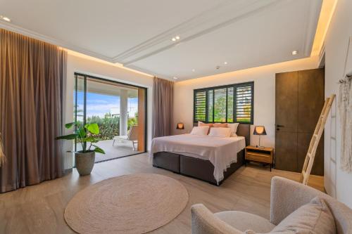a bedroom with a bed and a large window at The Shore 2 luxury beach front condo in Willemstad