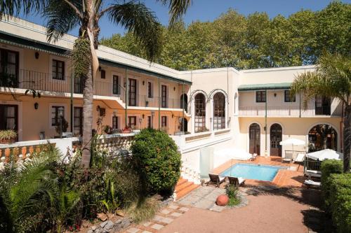 an exterior view of a house with a swimming pool at Don Antonio Posada in Colonia del Sacramento
