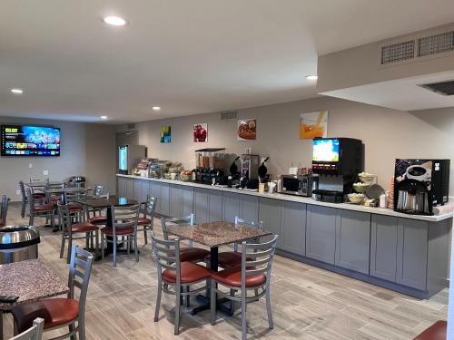 a restaurant with tables and chairs and a bar at Quality Inn Santa Fe New Mexico in Santa Fe