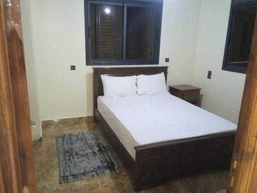 a bedroom with a bed in a room with a window at Appartement familial 3 in Oualidia