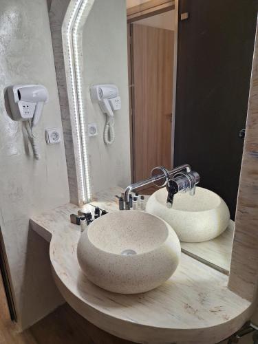 a bathroom with a sink and a mirror at Alta Vista Apartments in Agkidia